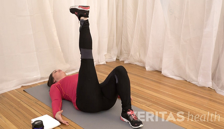 Woman performing the supine leg raise stretch